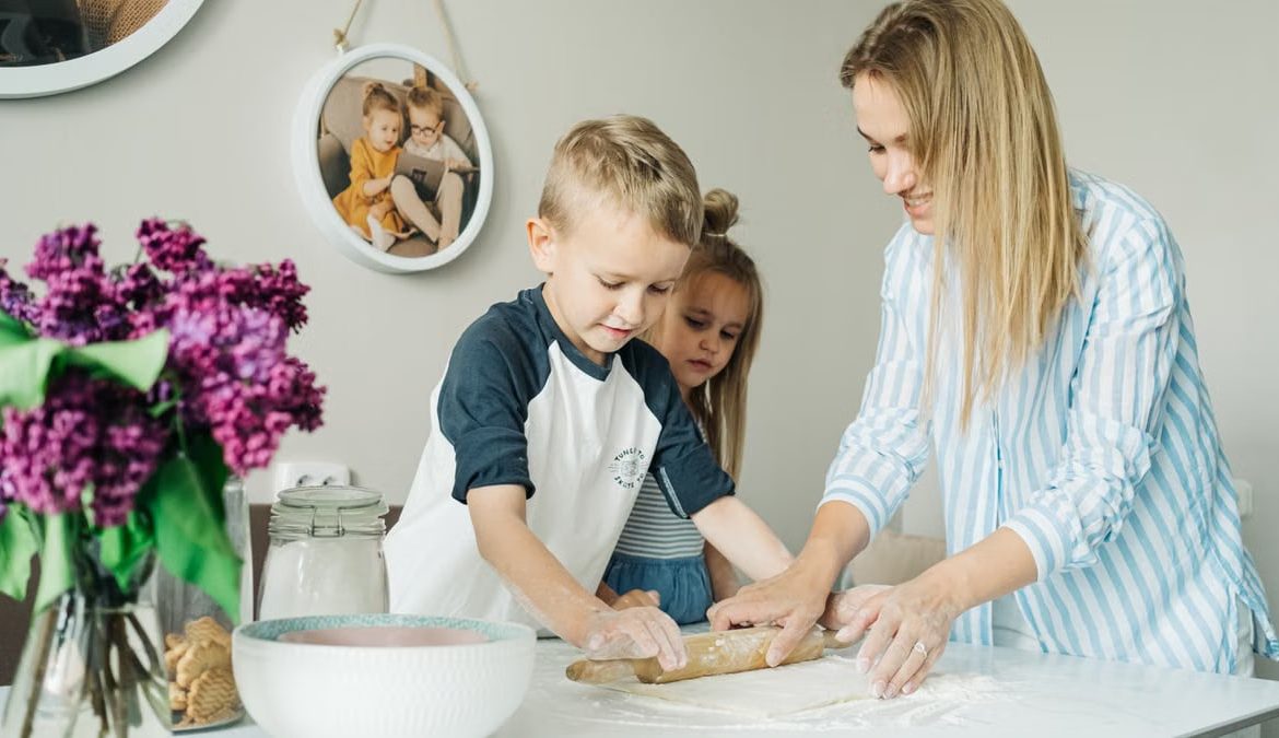 Mother and children enjoying a fun and messy baking session together at home.